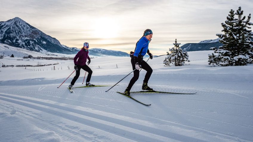 Skate skiers on Magic Meadows trails with Mt Crested Butte backdrop