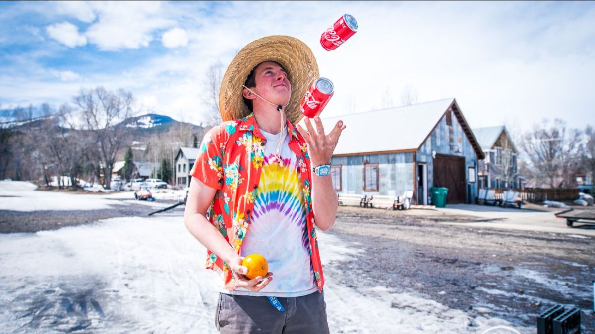 Crested Butte Nordic staff member juggling fruit and cans of soda