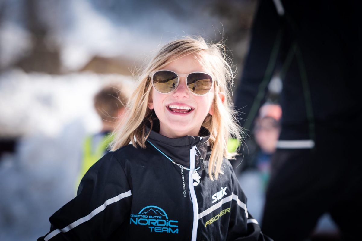 Big smiles from a young skier in the Juniors program with Crested Butte Nordic