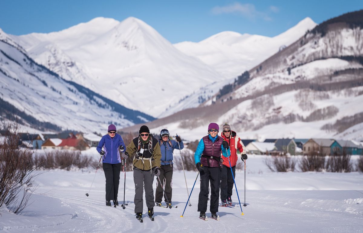 A group of skiers enjoying sunny trails near Crested Butte