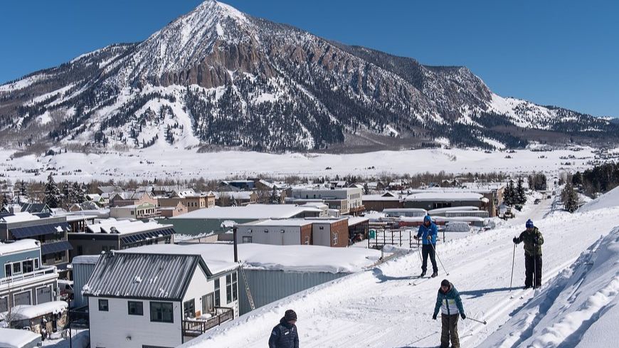 Skiers on a trail near town of Crested Butte