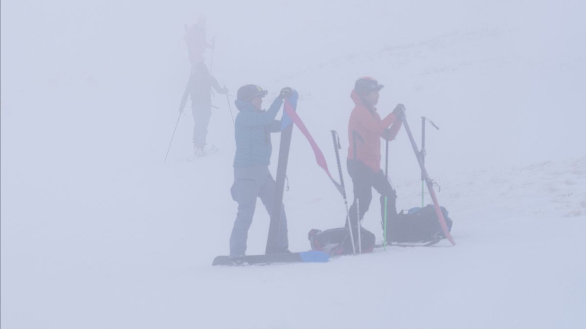 Racers in the Grand Traverse Ski preparing for an uphill in stormy conditions