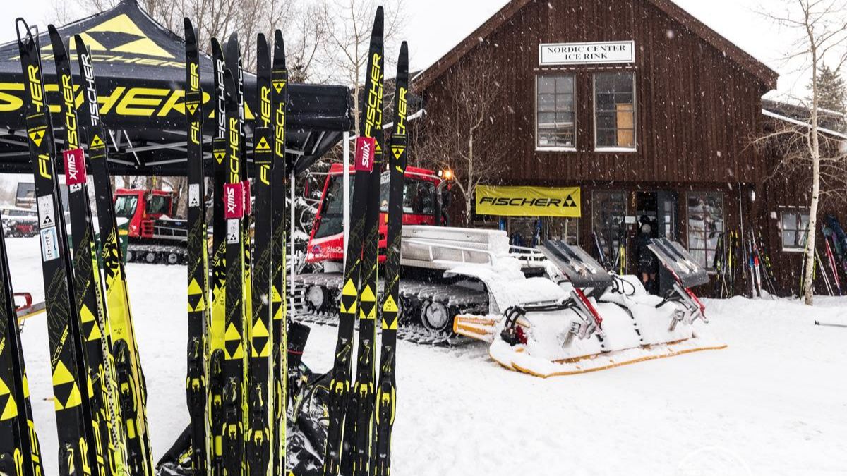 Fischer Skis demo fleet and CB Nordic snowcat outside the warming house
