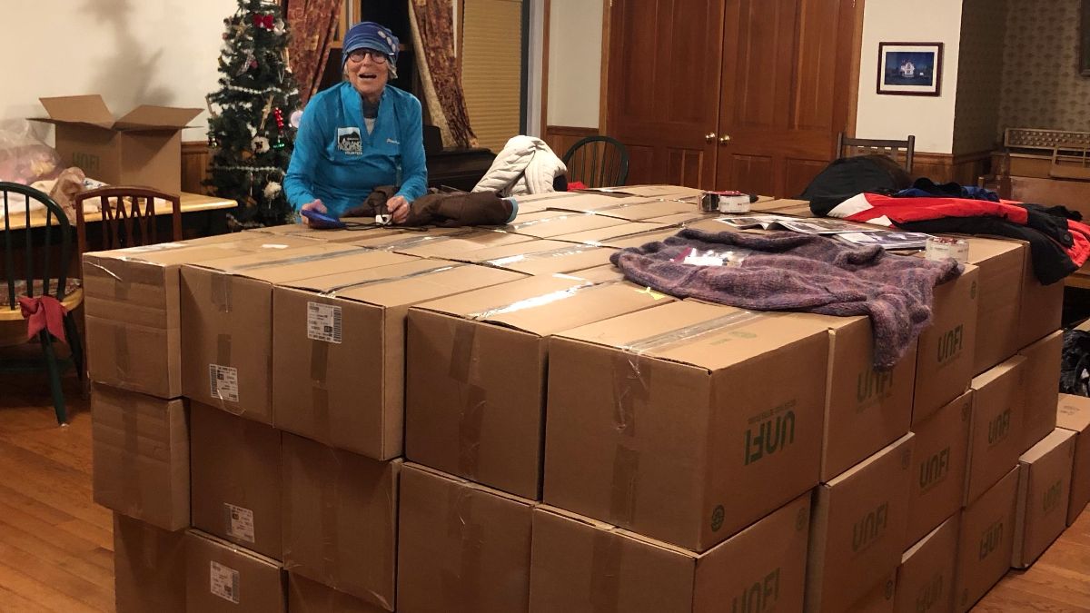 Local volunteer with a shipment of coats for displaced people in Ukraine