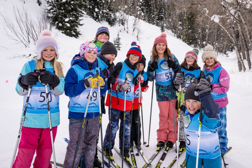 A group of kids gathers after a nordic race.