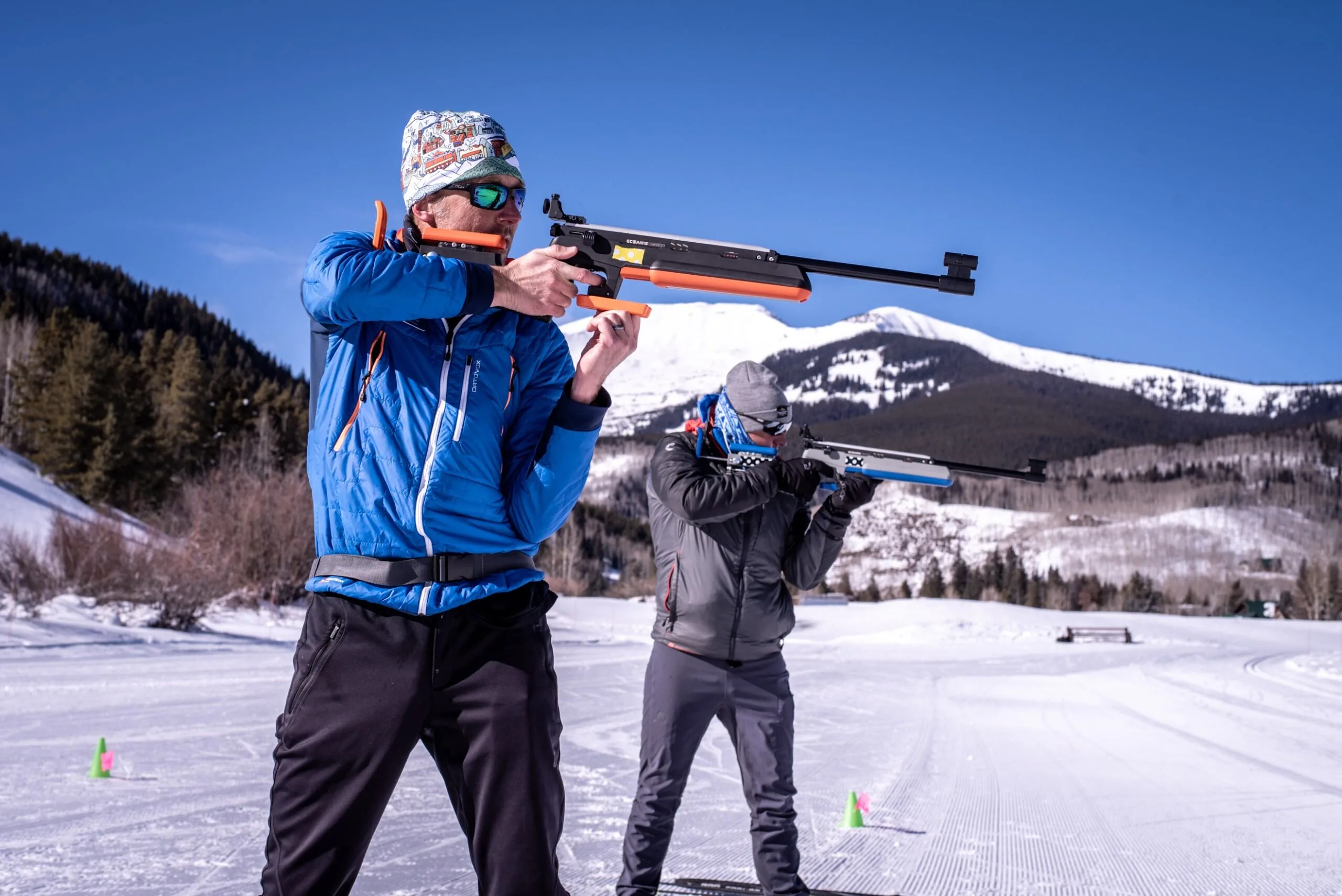 Adults practice biathlon skills with infrared rifles